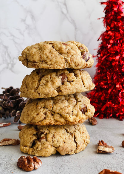 Stack of oatmeal cookies with a red decorative tree in the background