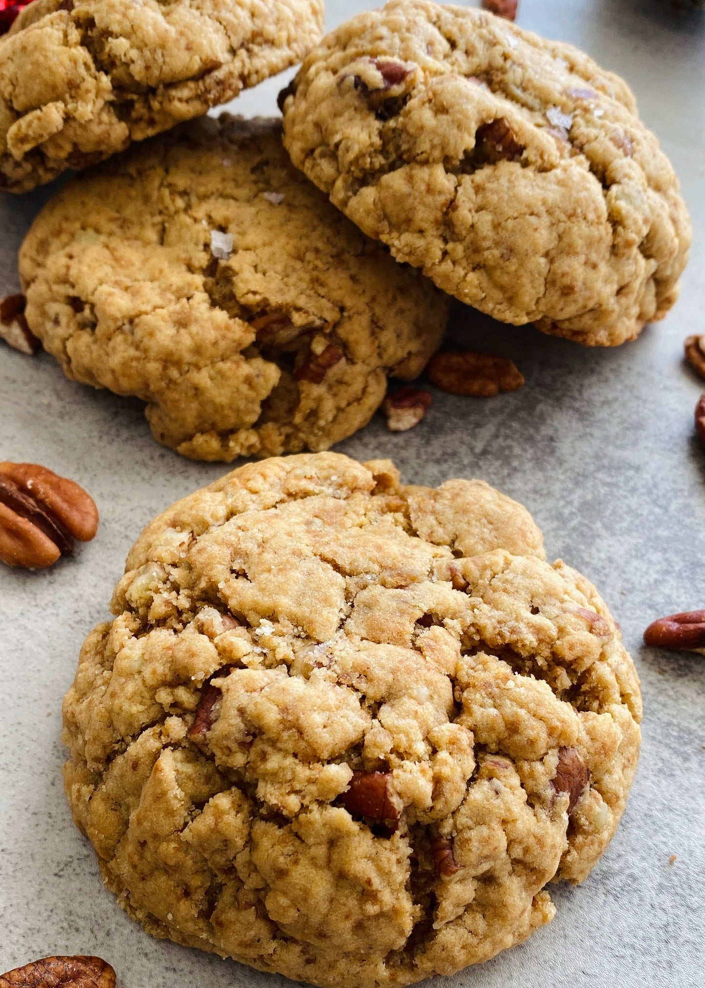Cookies with pecans on a textured surface