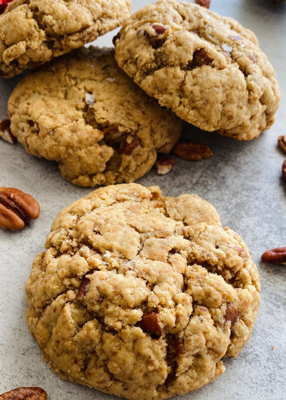 Cookies with pecans on a textured surface